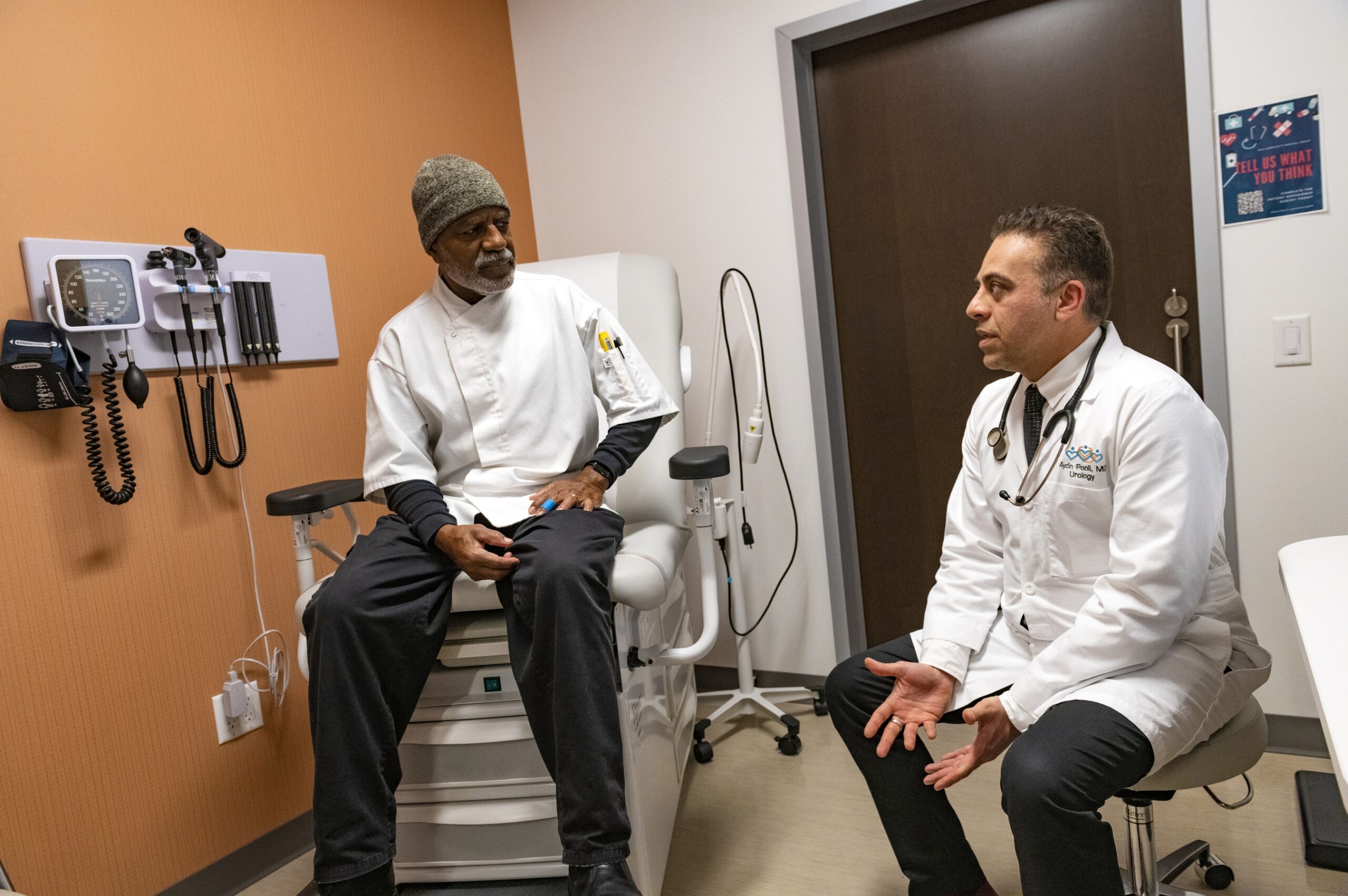 Dr. Aydin Pooli talking with a patient in the clinic