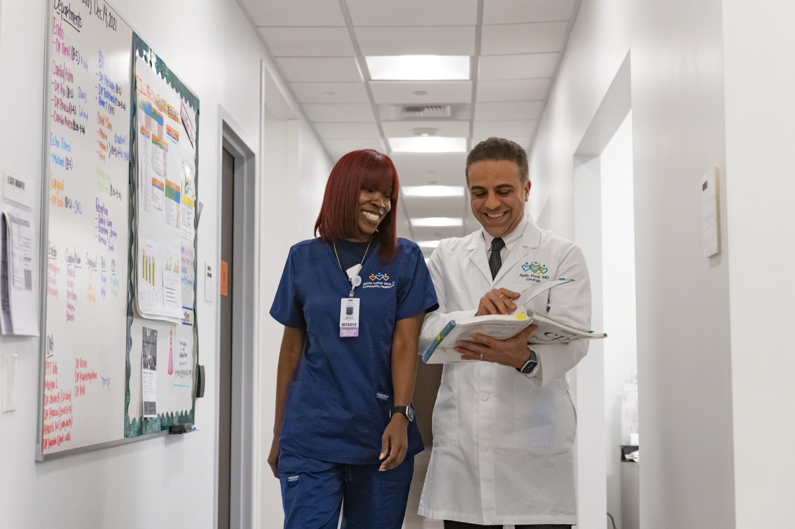 Dr. Aydin Pooli reviewing a chart with a nurse in the clinic